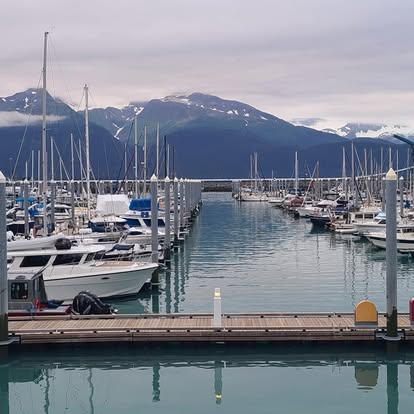 Marina with yachts and mountain backdrop